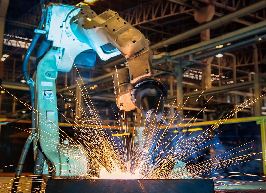 Insurance by Industry - A Manufacturing Machine at Work in A Warehouse